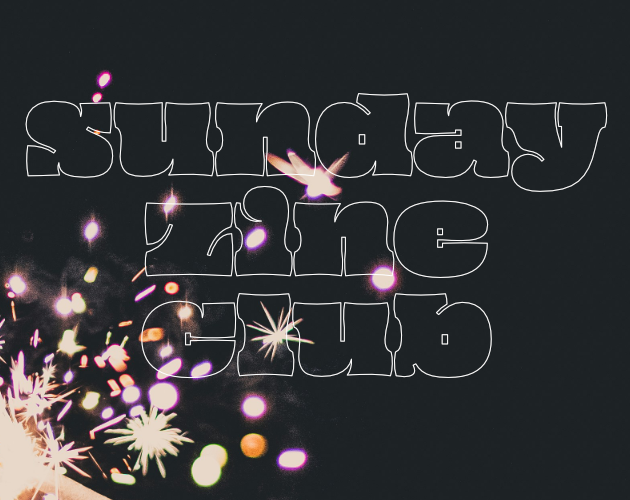closeup of a sparkler in pink, yellow, and orange against a black background. the words on top of the image read sunday zine club